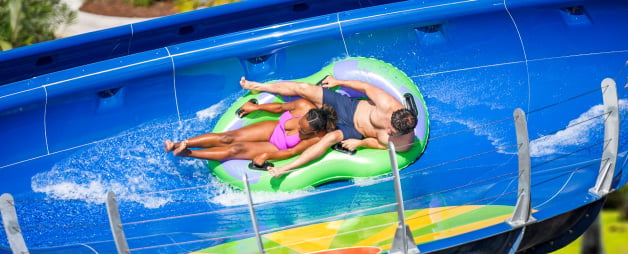 Two guests riding Rapids Racer water slide